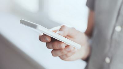 En mand bruger touch funktionen på sin smartphone